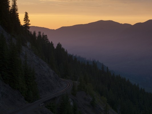 A smoky sunset flares out brightly in the Oregon Cascades at Tunnel 11 on Union Pacific's former Southern Pacific main line on July 8, 2010.