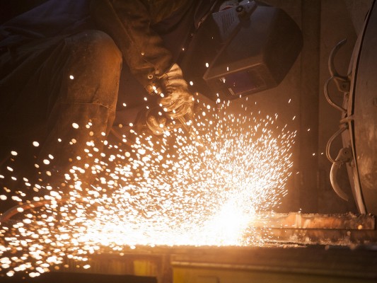 One of Portland and Western's diesel doctors uses a cutting torch during a main generator replacement on one of the railroad's locomotives at the Albany shops on November 5, 2009.