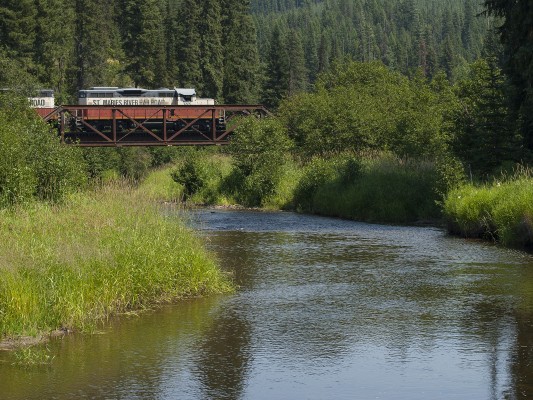 The St. Maries River Railroad's outbound Clarkia Logger crosses the railroad's namesake river between Emerald Creek and Clarkia, Idaho, in July 2007.