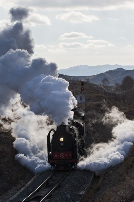 After meeting a freight train, a steam-powered passenger special departs Jingpeng Pass on a November afternoon in 2005.