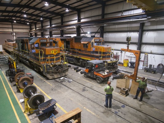 Portland and Western Railroad shop workers use an overhead crane to position a new power assembly for GP40-2 locomotive 3002 at Albany, Oregon, on May 8, 2009. Shot on assignment for <i>Locomotive</i> magazine.