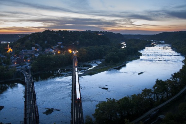 Westbound MARC commuter train crossing the Potomac River into West Virginia at Harpers Ferry just after sunset on an October day in 2007.