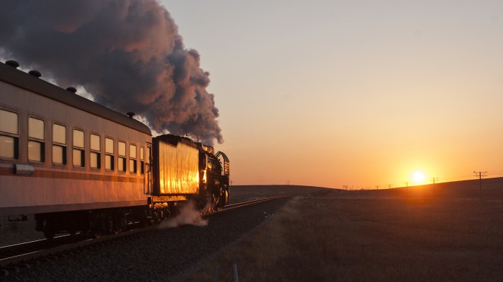 The Jitong Railway's morning passenger train greets the rising sun on the Inner Mongolian grasslands near Gulumanhan in October 2005.