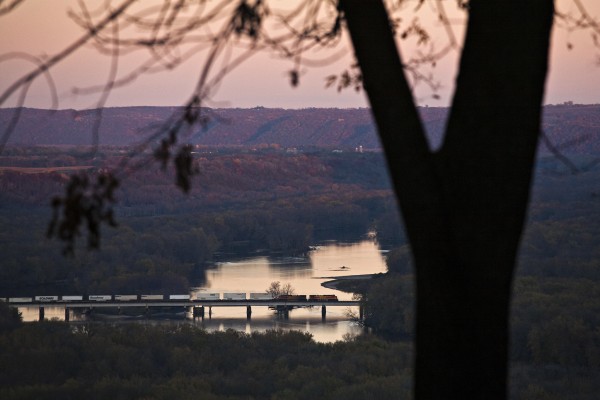 Eastbound BNSF Railway intermodal train crossing the Wisconsin River at Wyalusing, Wisconsin, as seen from Pikes Peak State Park in McGregor, Iowa, as the last rays of daylight spill onto the Wisconsin River Valley on October 20, 2012.