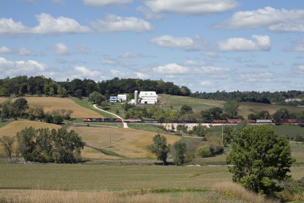 Canadian National westbound freight train M337 with three locomotives and 102 cars (30 loads and 72 empties) passing a farm near Julien, Iowa, on the climb out of the Mississippi Valley from Dubuque on the afternoon of September 9, 2012.